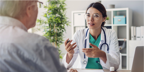 Image of a female doctor reading a chart to an adult female patient